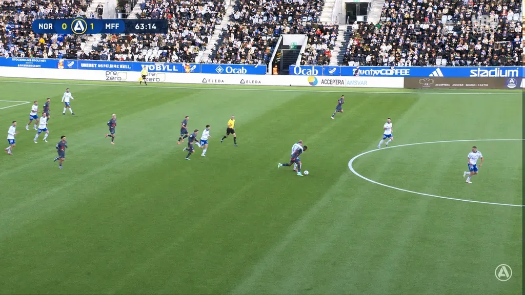 Wide football frame with a backlit, overexposed stand recovered to show crowd detail