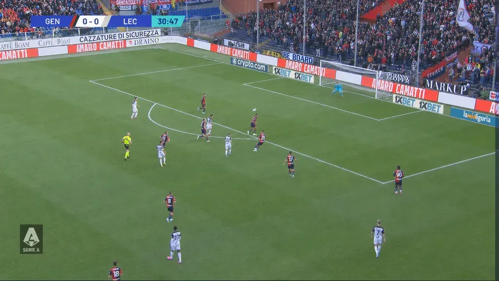 The same football frame after LivePictureAI, with even lighting across the pitch and the advertising boards readable again