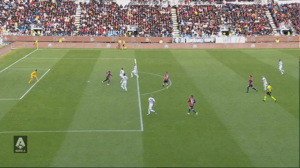Match footage with a blown-out, sunlit stand rebalanced against the shaded pitch