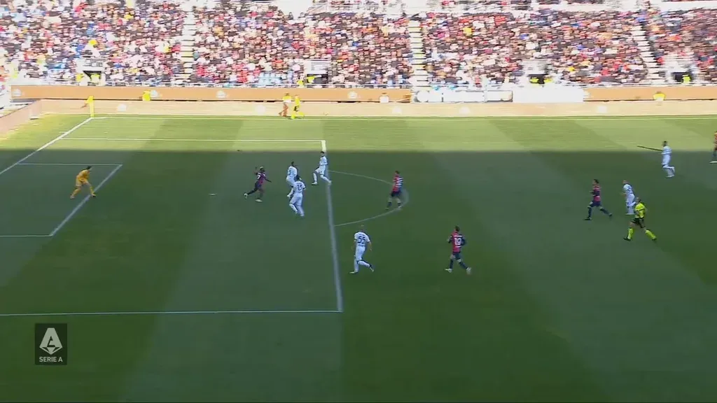 Football broadcast with a sunlit crowd and a pitch in shadow